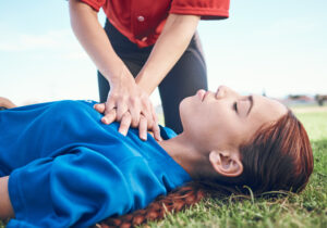 cpr outdoor and hands on chest women and help for heart attack symptoms
