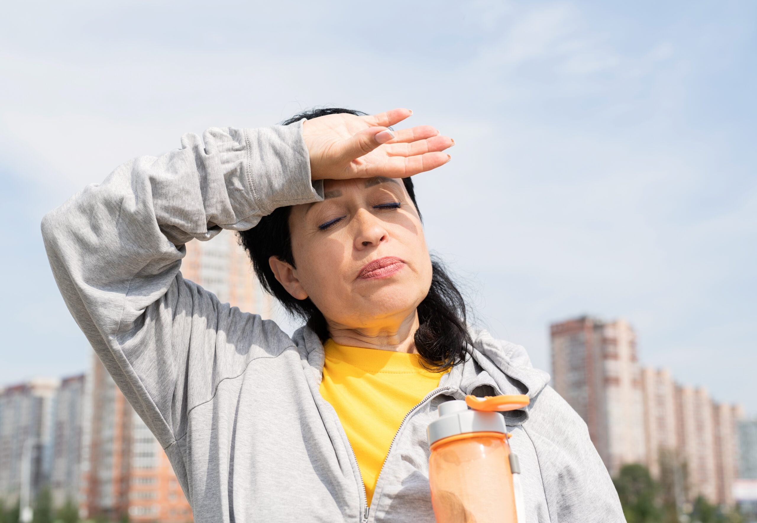 senior woman wiping out sweat after hard workout