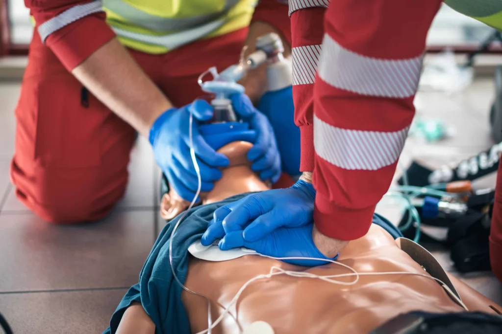 Perth instructor demonstrating AED operation on training mannequin