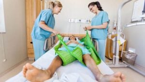 World Patient Safety Day - 2026 - two aged care workers using slide sheets to reposition a patient