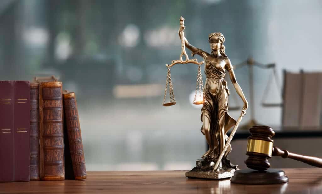 legal scene - desk, books, lady justice statue