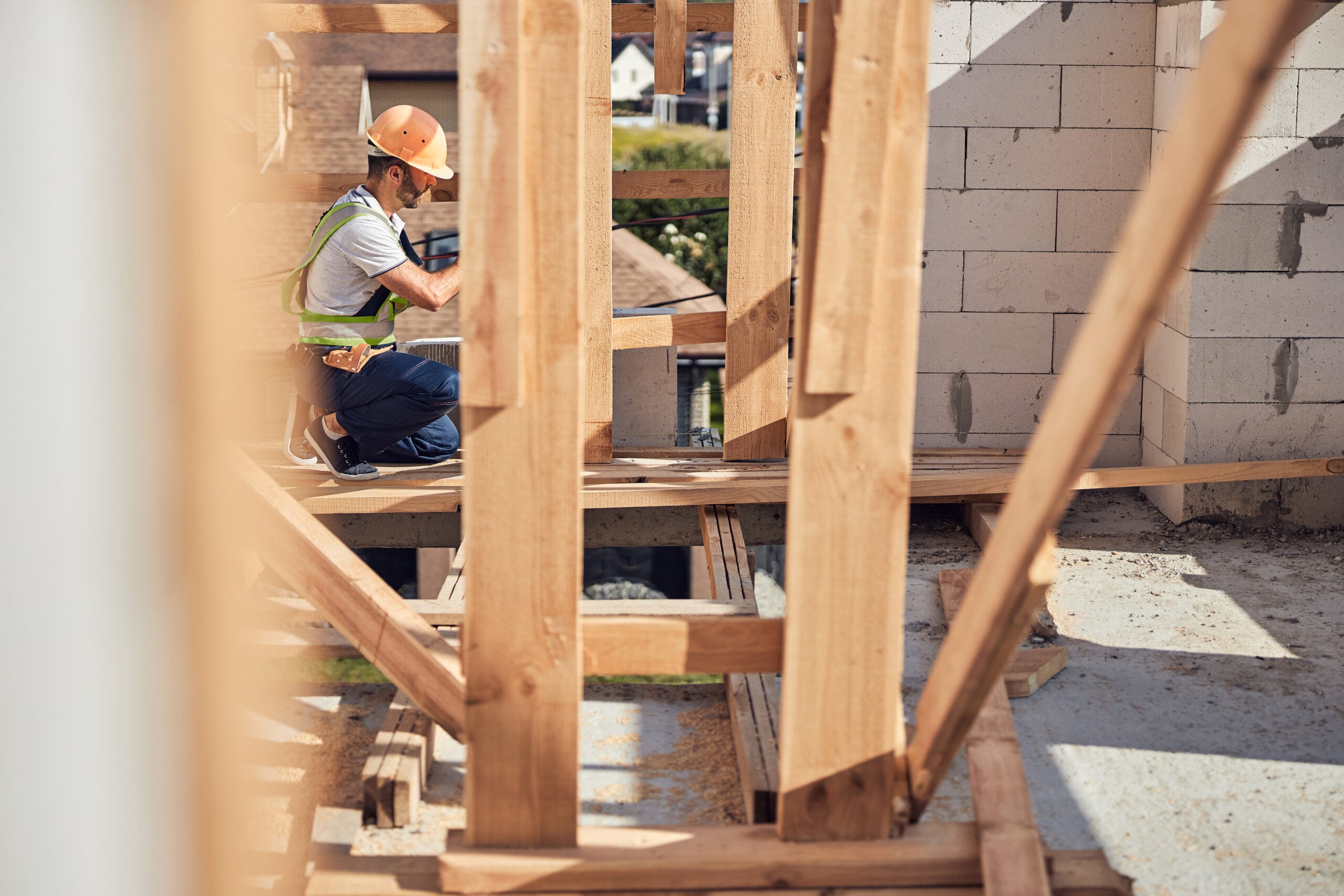 Tradies National Health Month 2026 - Competent foreman being on the top floor of the building while fastening self-tapping screws to the beam