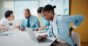 National Pain Week - woman-back-pain-and-laptop-in-meeting-at-office