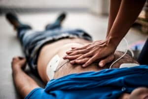 World Heart Day - adult-receiving-life-saving-first-aid-with-defibrillator