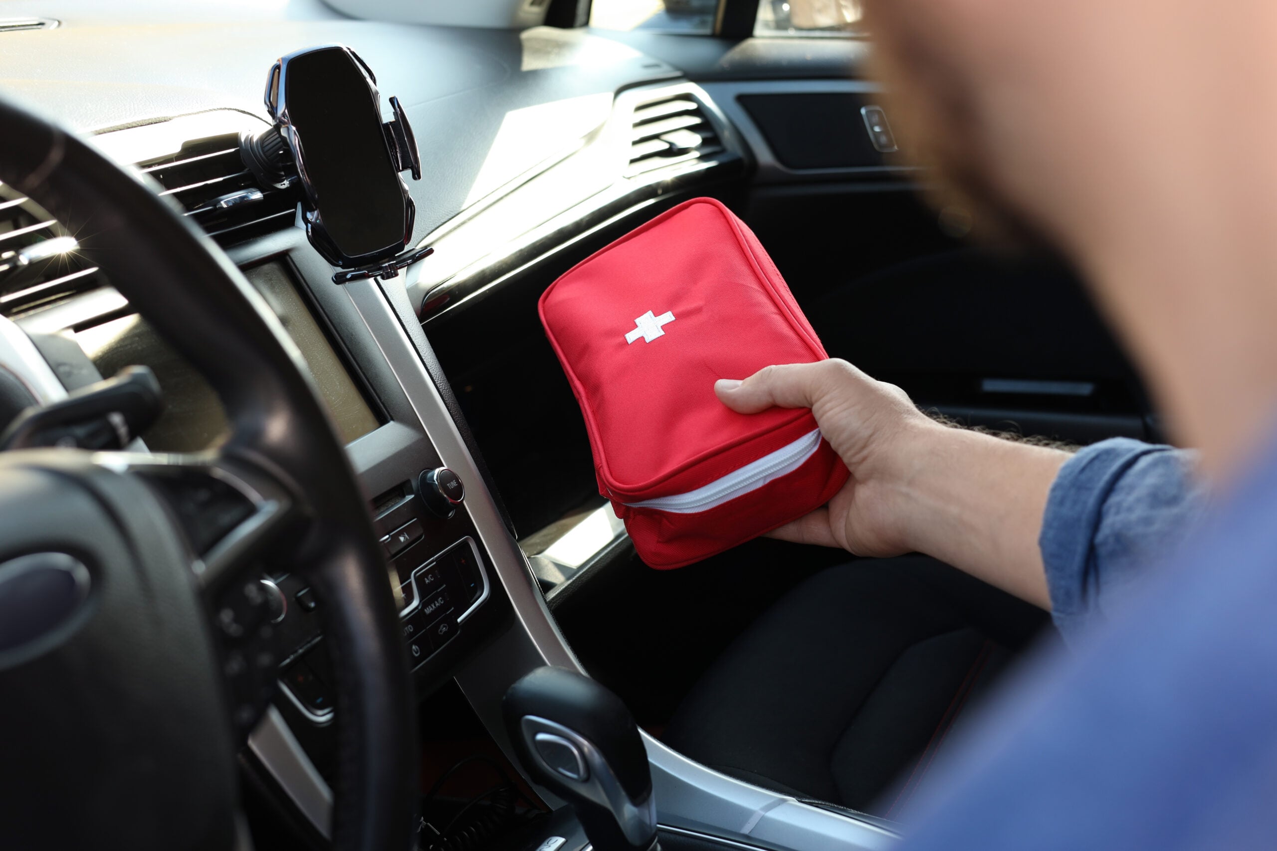 National Tradesmen Day - Tradesman with first aid kit inside van, closeup