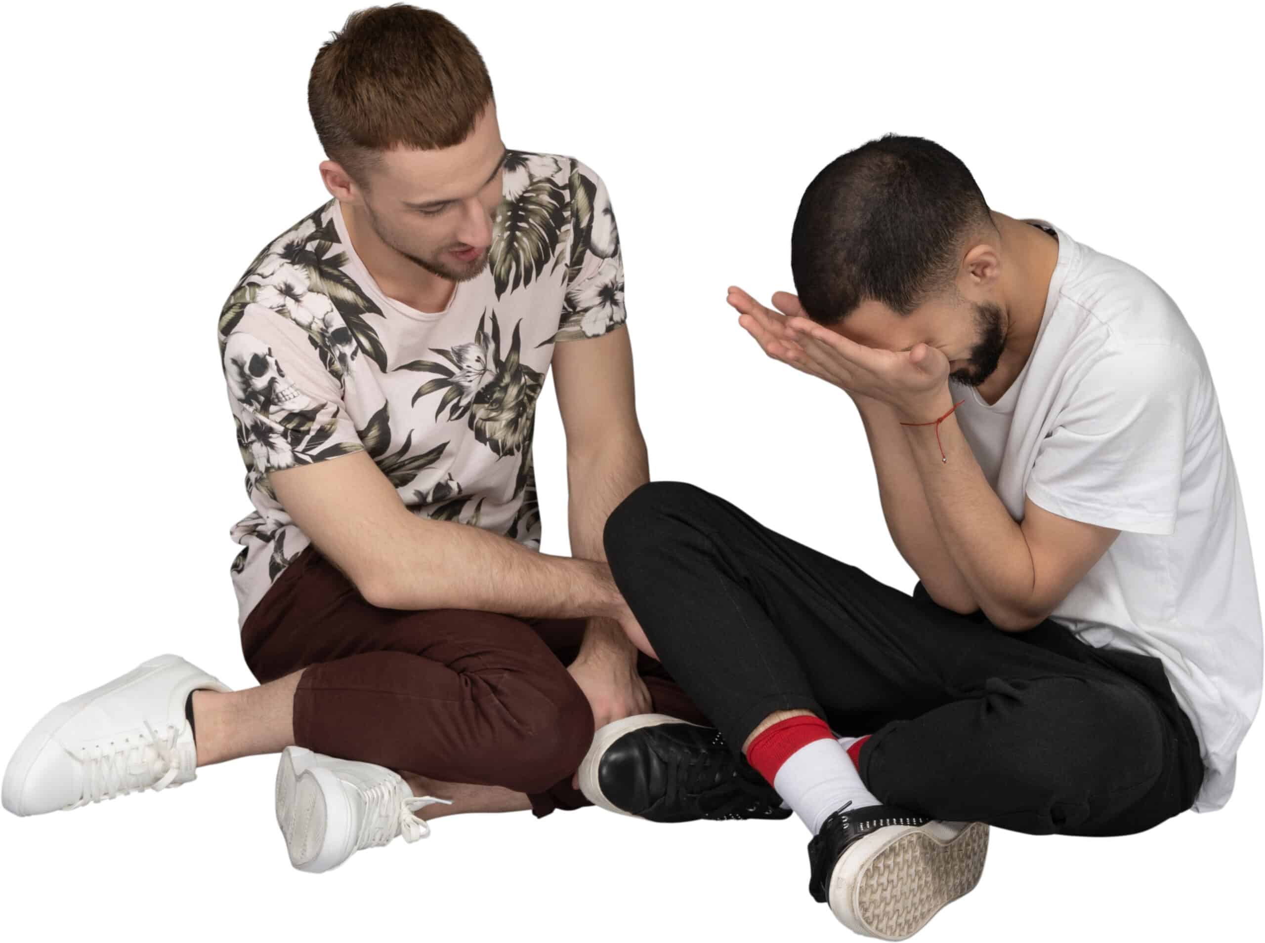 two men sitting on the floor and looking at each other
